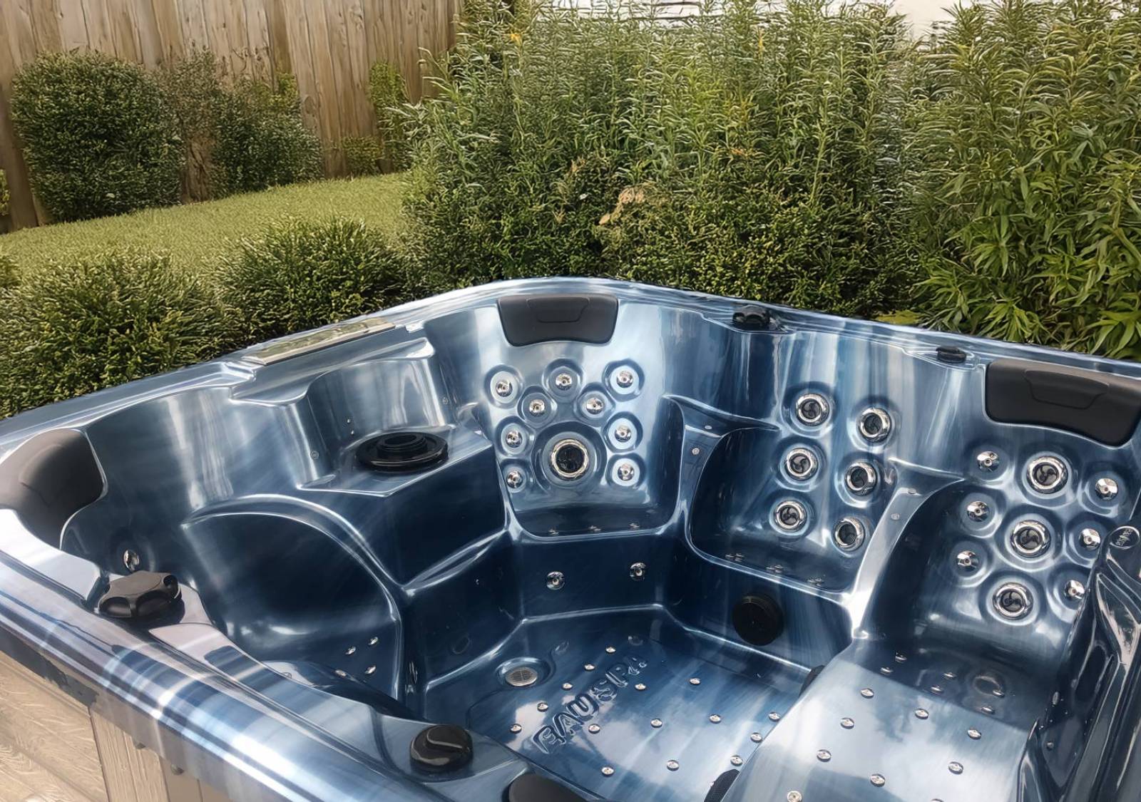 Le modèle Cuba dans sa finition “Bleu Océan”, harmonieusement installé dans un espace extérieur végétalisé à Bagnols-sur-Cèze.